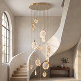 Marble cascading chandelier with amber agate discs in a double-height stairwell