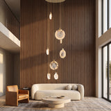 Marble cascading chandelier in a warm double-height living room