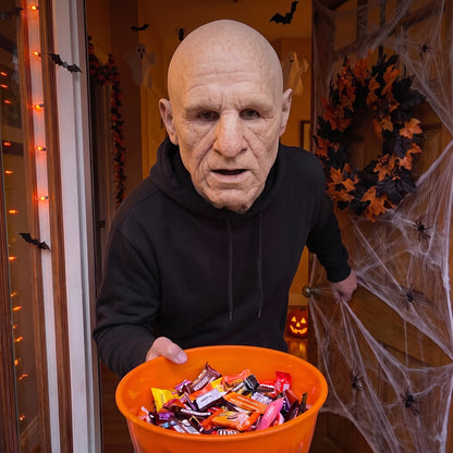 Hollow-Eyed Ghoul latex mask worn at a Halloween front door