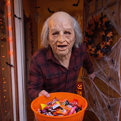 Grinning Grey Elder latex mask worn at a Halloween front door