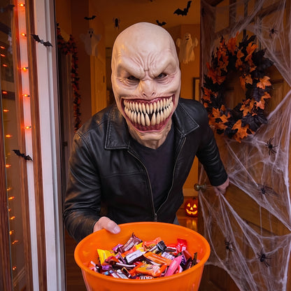 Fanged Monster latex mask worn at a Halloween front door