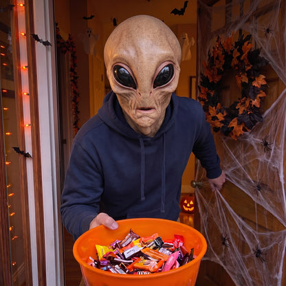 Roswell Alien latex mask worn at a Halloween front door