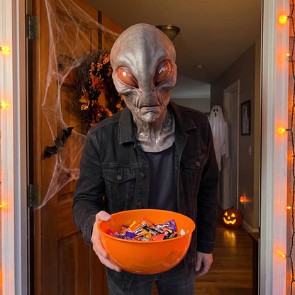 Glowing-Eye Alien latex mask worn at a Halloween front door