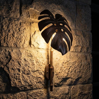 Monstera - mounted on stone wall at night