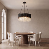Noctis black crystal chandelier above a round walnut dining table
