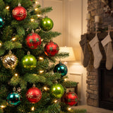 red, green and gold ornaments hanging in a Christmas tree