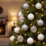 white and silver ornaments hanging in a Christmas tree