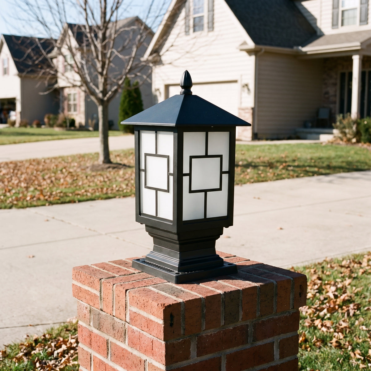 Oakmont framed glass post light on a brick driveway pillar on a clear late-autumn day