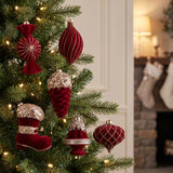 Red velvet glam ornaments hanging in a Christmas tree in a classic living room
