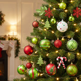 Red, green and white glitter ornaments hanging in a Christmas tree