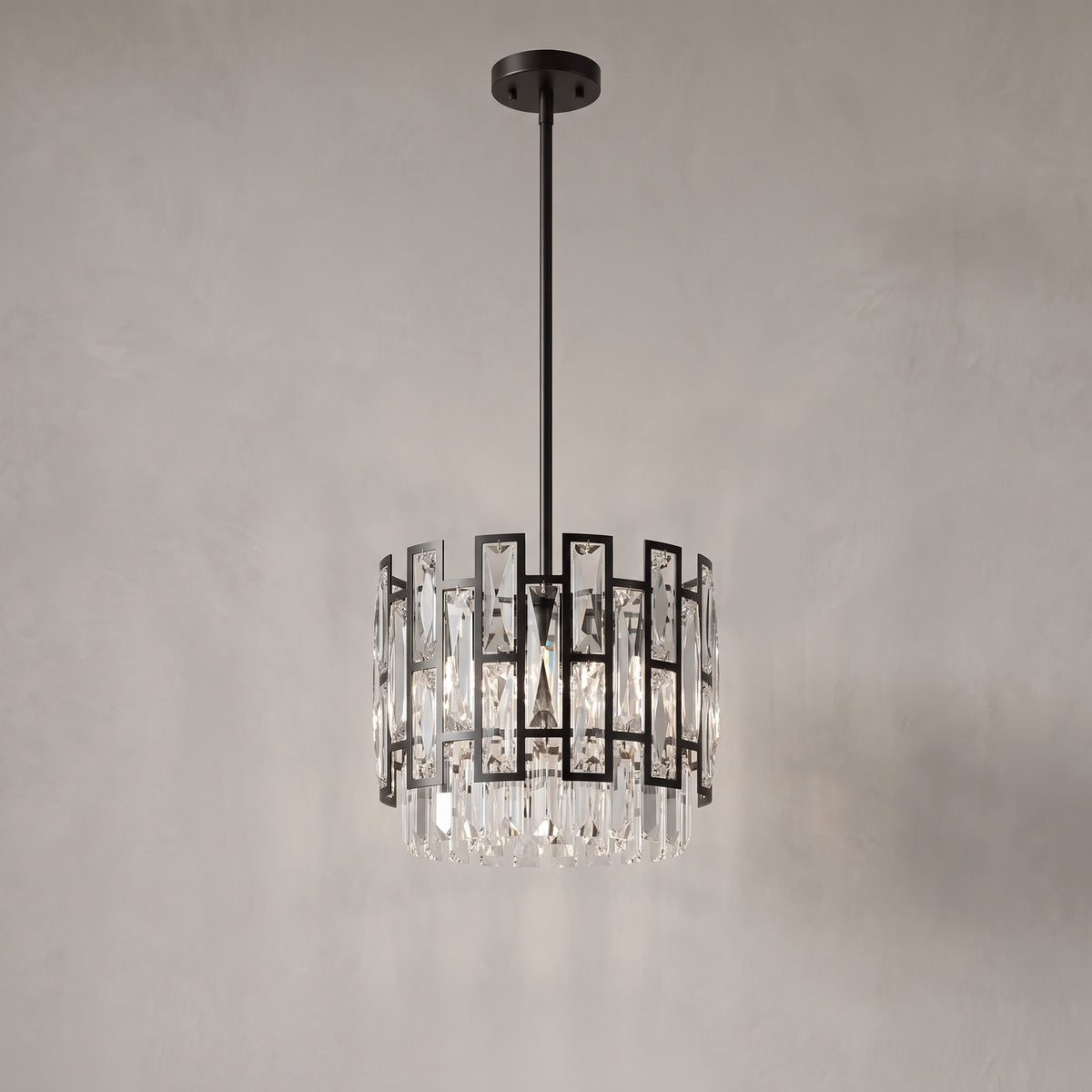 Raven mini black crystal pendant on a warm light grey studio background
