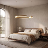 Gold-plated ring chandelier, medium size, above the foot of a walnut bed
