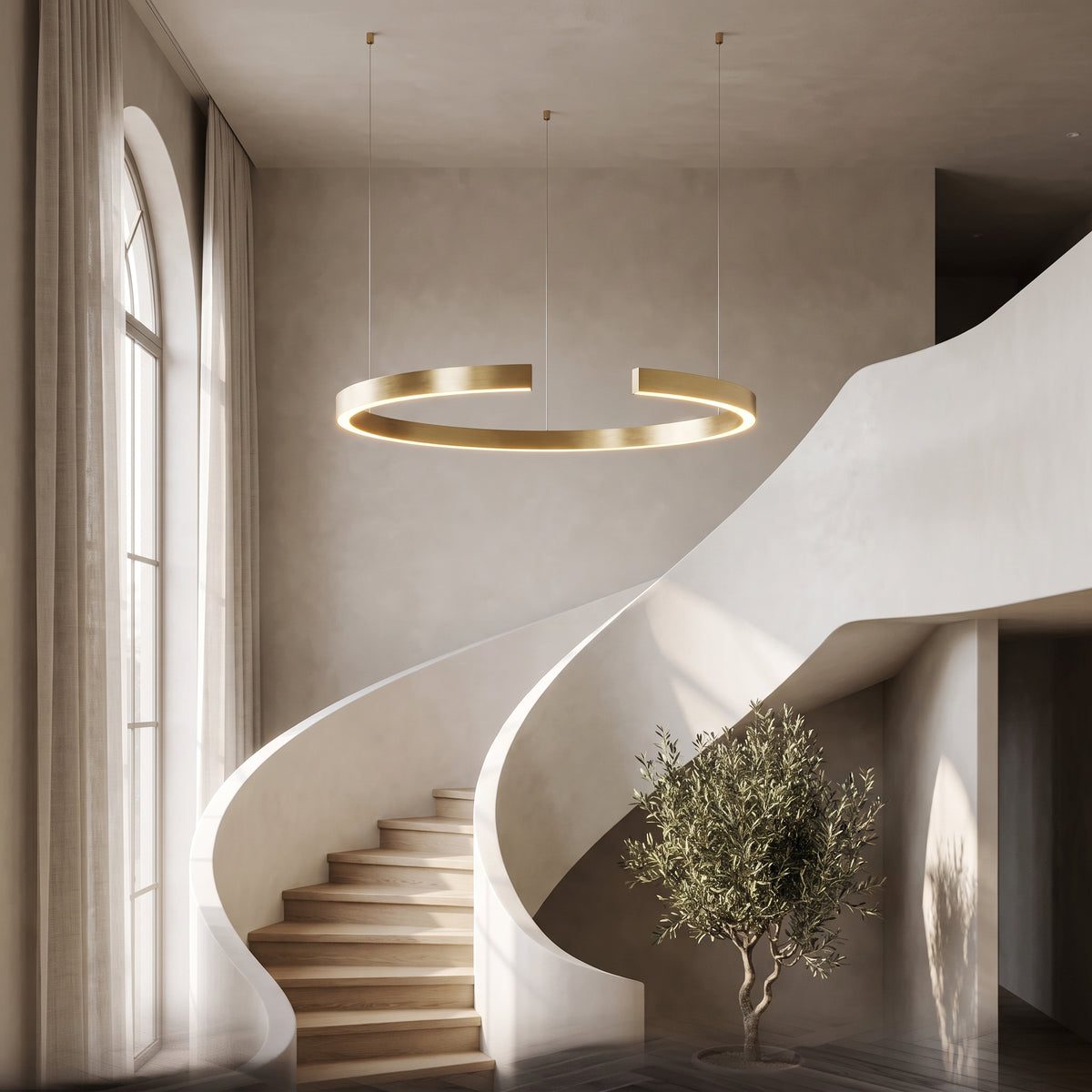 Gold-plated ring chandelier suspended in a curved stairwell