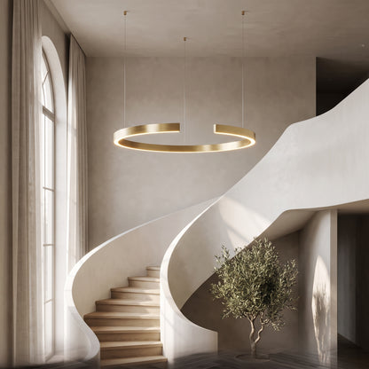 Gold-plated ring chandelier suspended in a curved stairwell
