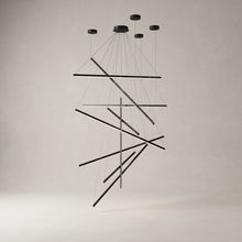 Rowan linear chandelier with 9 light bars on a warm light grey studio background
