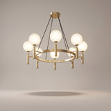 Solenne brass chandelier on a warm light grey studio background