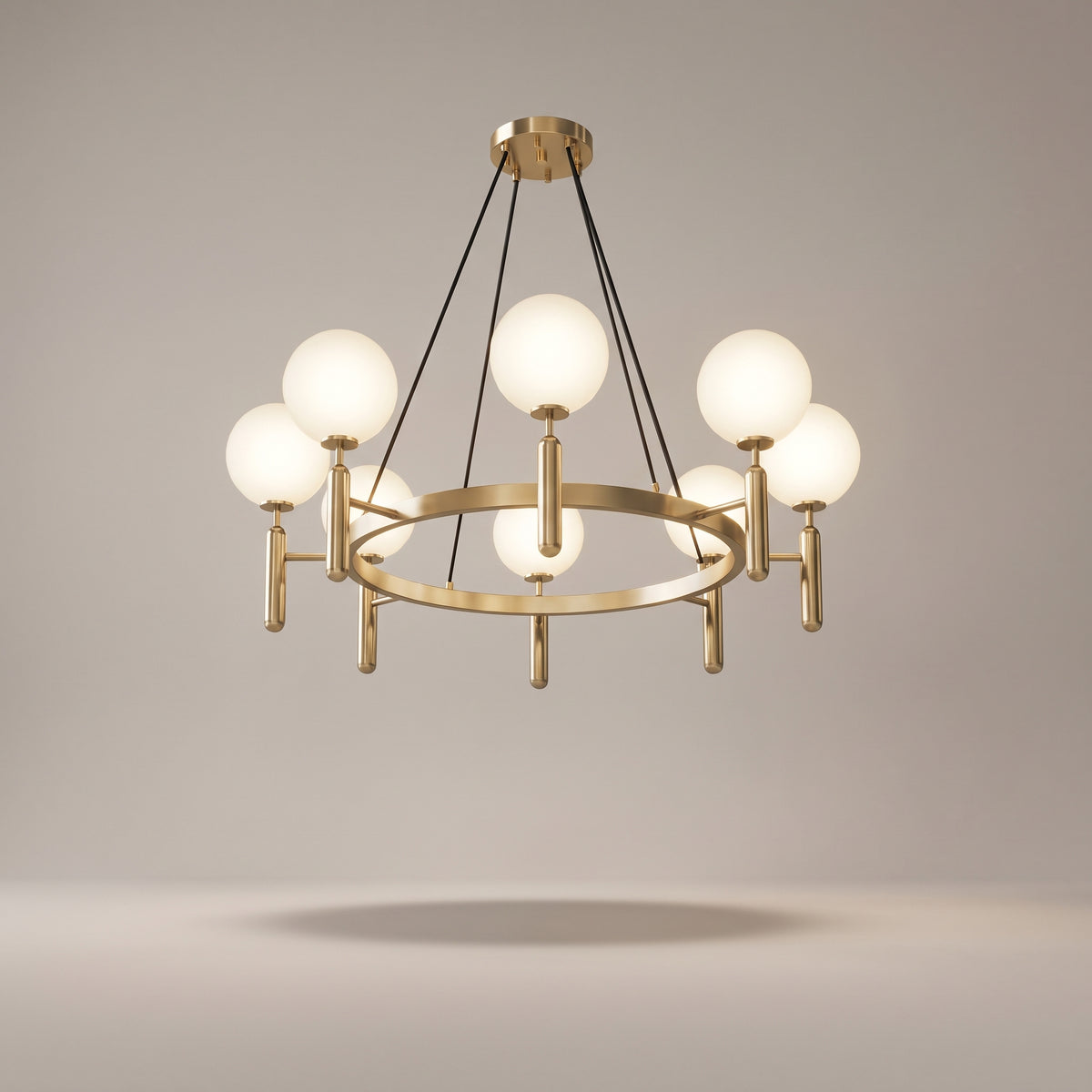 Solenne brass chandelier on a warm light grey studio background