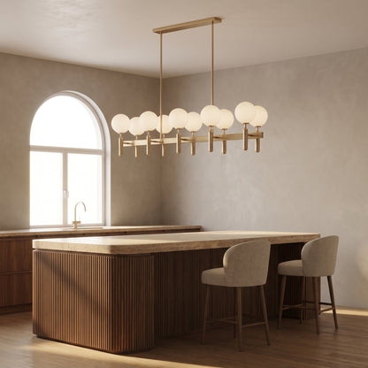 Solenne rectangle brass chandelier above a walnut kitchen island