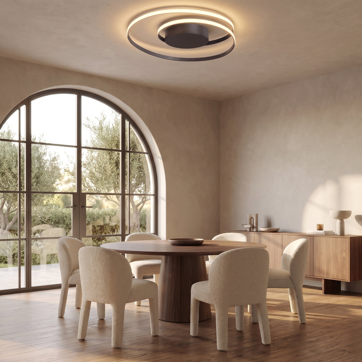 Linnea spiral LED ceiling light above a round walnut dining table