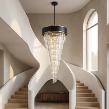 Vesper black and gold spiral crystal chandelier cascading in a double-height stairwell