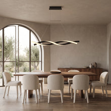 Ondine linear wave LED pendant above a long walnut dining table