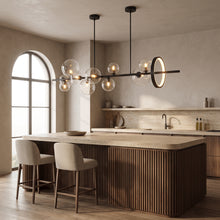 Wren black linear glass globe chandelier with gold ring above a walnut kitchen island