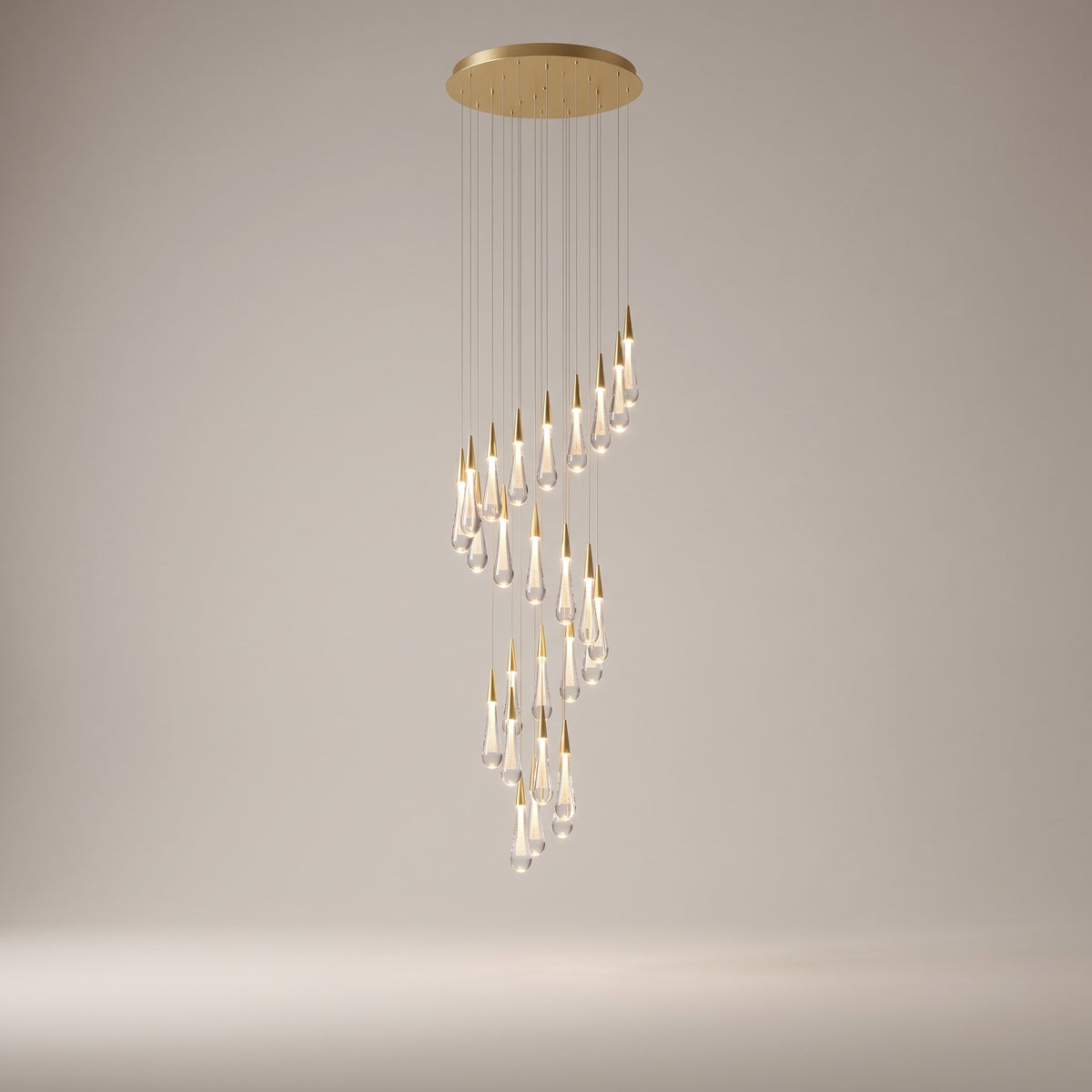Zephyra spiral crystal chandelier on a warm light grey studio background